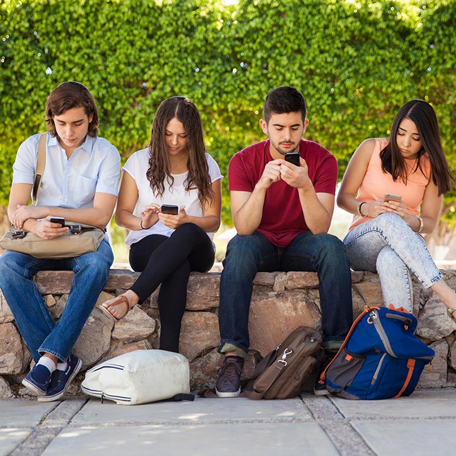 image of 4 people on their phones for a blog about pokemon go and marketing