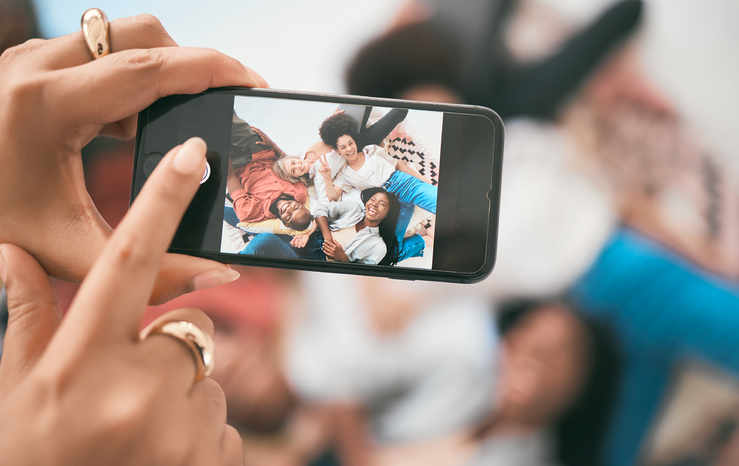 person taking group photo using smartphone