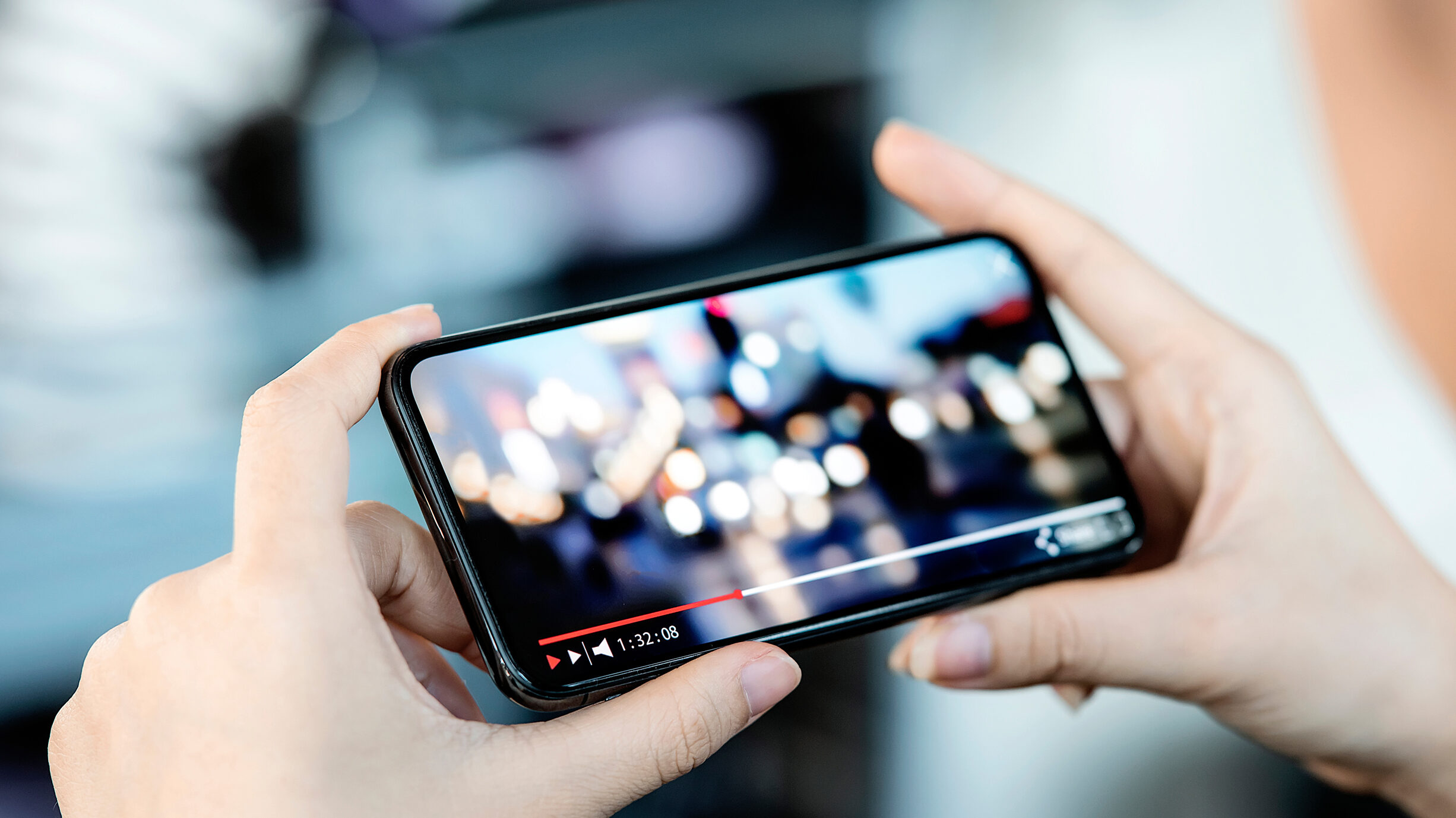 person holding phone watching video